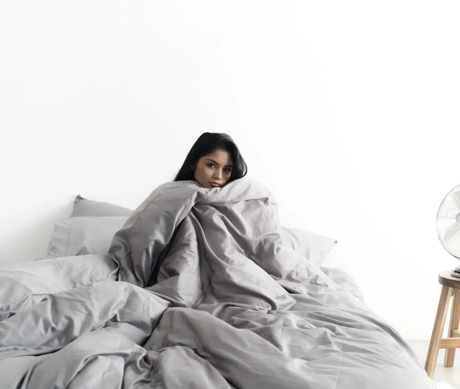 A woman is happy after sleeping on Miracle Sheets